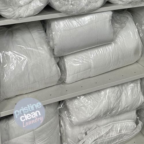 Clean duvets packaged and shelved at Pristine Clean Laundry in Cheshire ready for customer collection and delivery