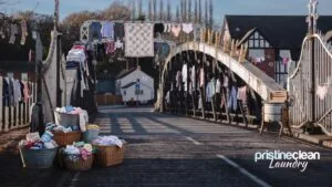 Comical parody of washing hanging from Northwich Town Bridge — no laundrette needed, Pristine Clean Laundry collects from your door